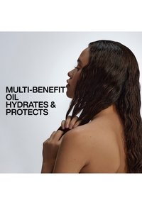 Woman with long wet hair holding strands, text reads "Multi-benefit oil hydrates & protects" on a light gray background.