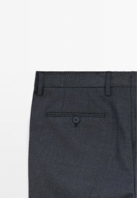 Dark gray tailored trousers made of textured fabric, featuring belt loops, a single back pocket with a button, and a flat front design.