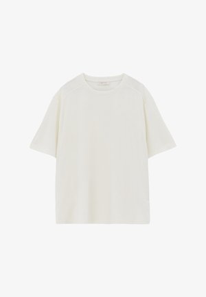 Yksinkertainen valkoinen lyhythihainen t-paita, jossa pyöreä pääntie ja rento istuvuus. Paidassa on pieni OXXO-merkintä kauluksen sisäpuolella.