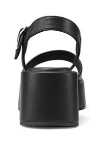 I sandali platform neri presentano una fascia ampia attorno alla caviglia e un materiale sintetico testurizzato, con un tacco grosso e una soletta liscia.