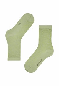 Chaussettes vertes à motif avec un design texturé, dotées d'un bord côtelé et d'un détail de logo. Le matériau semble lisse et léger.
