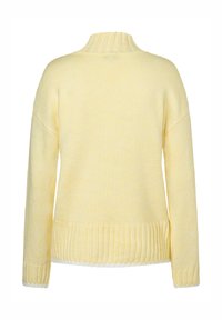 Yellow knitted sweater with a high neck, ribbed cuffs, and hem. The texture is soft and slightly textured, designed for a relaxed fit.