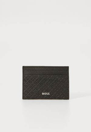 Black cardholder in textured material, featuring geometric embossing, multiple card slots, and a silver logo on the front.