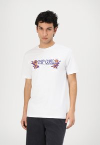 White cotton t-shirt featuring colorful floral graphic print on the front, round neckline, and short sleeves. Standard fit and smooth texture.