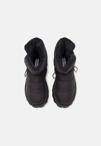Pair of black insulated winter boots with thick rubber soles and fleece lining, viewed from above on a white background.