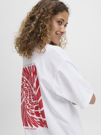 White oversized t-shirt featuring bold red graphic text in a spiral design on the back. Round neckline and short sleeves.