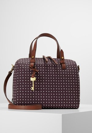 Sac à main rectangulaire marron avec motif de cœurs blancs, poignées et bandoulière en cuir marron, et un porte-clés doré suspendu.