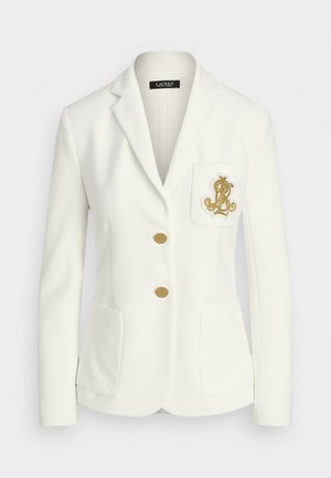 Bílý blazer s texturovaným povrchem, zlaté knoflíky a náprsní kapsa s vyšívaným zlatým logem. Součástí jsou dvě přední kapsy.