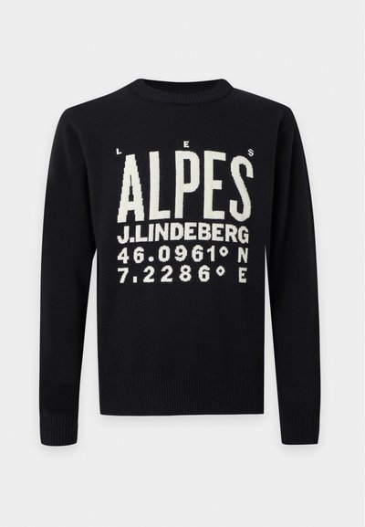 Pull noir à manches longues avec texte blanc indiquant "LES ALPES," "J. LINDEBERG," et coordonnées géographiques 46.0961° N, 7.2286° E sur le devant.