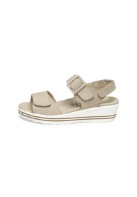 Beige sandal with adjustable buckle, open toe, cushioned footbed, and white wedge sole featuring brown stripes. Smooth texture, casual design.
