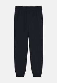 Svarta träningsoveraller tillverkade av mjukt, stretchigt tyg. Har en elastisk midja och ribbade ärmslut. Rakt bensdesign utan synliga mönster.