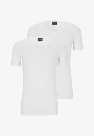 Two white short-sleeve T-shirts made of cotton with a V-neck design. Each has a smooth texture and minimalistic style. Black label visible.