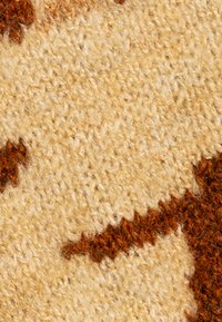 Wollen tapijt met een textuur oppervlak, voorzien van een beige achtergrond en abstracte bruine patronen, die een warm kleurenpalet tonen.
