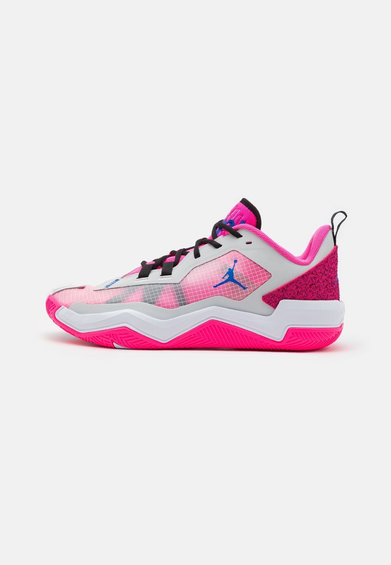 Chaussure de sport basse rose et grise avec des lacets noirs, un logo Jumpman bleu et une semelle texturée rose vif.