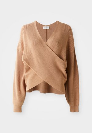 Beige knit wrap sweater with V-neck, long sleeves, and ribbed texture, displayed on a white background.
