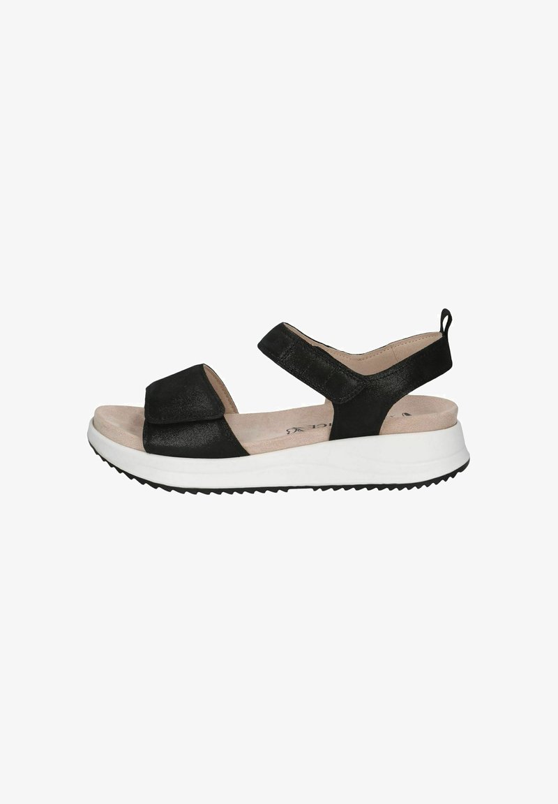 Sandale noire avec tige texturée, sangle ajustable et semelle blanche rembourrée. Caractérisée par un léger talon et une semelle en caoutchouc noire à motif.