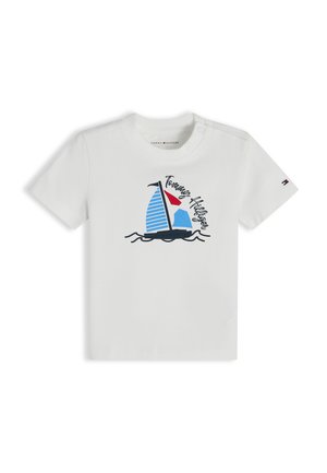 T-shirt blanc pour tout-petit avec un graphisme de voilier bleu et rouge et le texte "Tommy Hilfiger" sur le devant, ainsi qu'un petit logo sur la manche gauche.