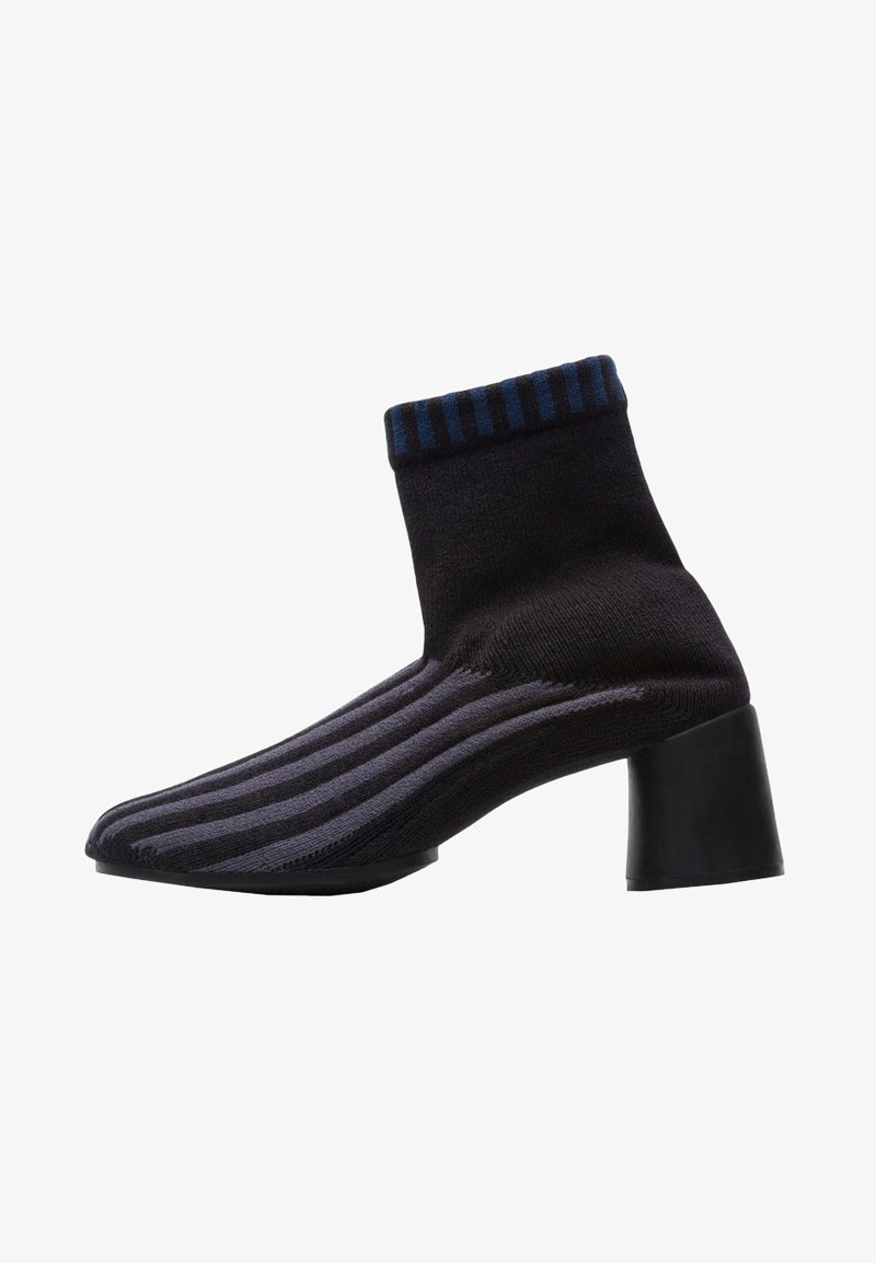Black knitted ankle boot with blue striped top, pointed toe, purple and black horizontal stripes, and a chunky black heel.