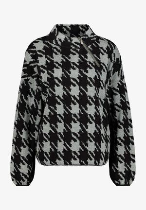 Pull-over à motif pied-de-poule noir et gris avec un col montant et un détail de fermeture éclair diagonale sur l'épaule gauche.