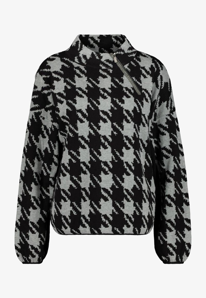 Pull-over à motif pied-de-poule noir et gris avec un col montant et un détail de fermeture éclair diagonale sur l'épaule gauche.