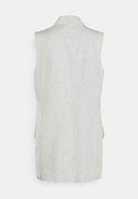 Ärmös ljusbeige linväst med höga kragar, visad bakifrån mot en vit bakgrund.