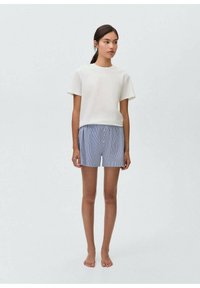 White short-sleeve cotton t-shirt paired with blue striped cotton shorts featuring an elastic waistband and two buttons at the front.
