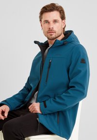 Teal softshell jacket with black accents, front zip, and a hood; features zippered chest pocket and adjustable cuffs.