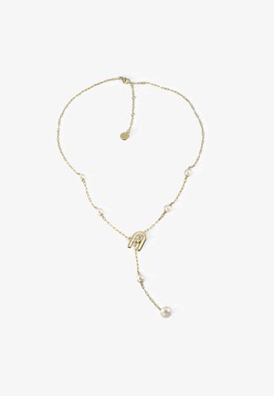 Arany lánc nyaklánc kerek fehér gyöngyökkel és egy U alakú medállal, amelyben átlátszó kő található, létrehozva egy finom dizájnt sima textúrákkal.