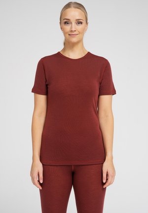 Rostfarvet, kortærmet t-shirt med ribbet tekstur, rund halsudskæring, kombineret med matchende stramme bukser. Glat stof og minimalistisk design.