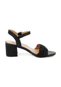 Sandalo nero con tacco spesso e cinturino alla caviglia regolabile. Presenta una parte anteriore annodata e una tomaia in tessuto texture.