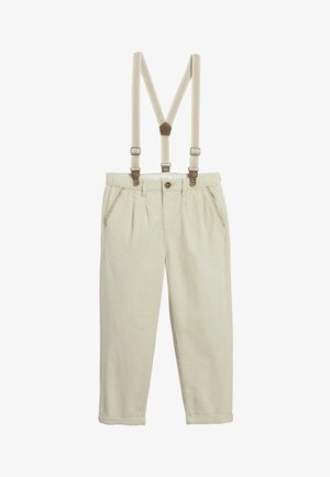 Beige Cordhosen mit aufgerollten Säumen und verstellbaren beigen Hosenträgern, die mit braunen Lederakzenten befestigt sind.
