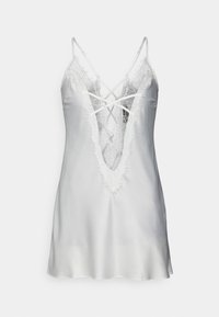 Vestido de seda blanca con un escote en V profundo y detalles de encaje. Presenta tirantes entrecruzados y bordes con flecos alrededor del escote.