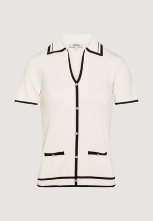 Cardigan crema a maniche corte con bordi neri, bottoni a perla, colletto e due tasche frontali, taglia small.