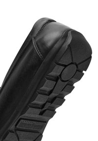 Schwarze Lederschuhe mit runder Zehenpartie, ausgestattet mit einer strukturierten Gummisohle und einem ausgeprägten Profilmuster für besseren Halt.