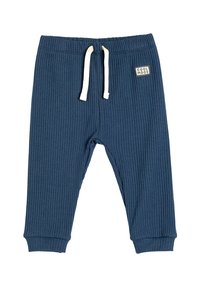 Pantalones de chándal de ribete en color marino con cintura elástica, cordón blanco y parche con logo. Puños en los tobillos para un estilo ajustado. Textura suave.