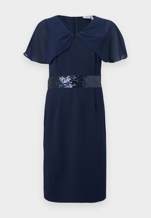 Abito blu navy fino al ginocchio con maniche a mantella trasparenti e una cintura con paillettes, dotato di chiusura posteriore con cerniera.