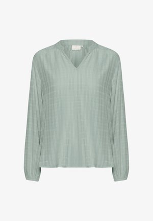 Lys grøn bluse med lange ærmer, V-udskæring, blød tekstur og subtile lodrette striber. Har elastiske manchetter og løs pasform.