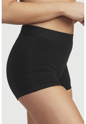 Musta korkeavyötäröinen shortsimalli, joka on valmistettu venyvästä kankaasta. Siinä on sileä vyötärö ja tiukka muotoilu, jossa on yksinkertaisia ompeleita.