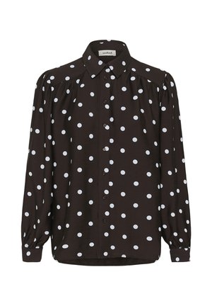 Bruine blouse met lange mouwen en witte stippen, knoopsluiting aan de voorkant, puntige kraag en licht opgeblazen mouwen. Zachte, gestructureerde stof.