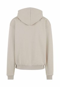 Beige hettegenser med myk tekstur, med snor i hetten, senket skuldre og ribbede mansjetter og hem. Bakview viser minimal design.