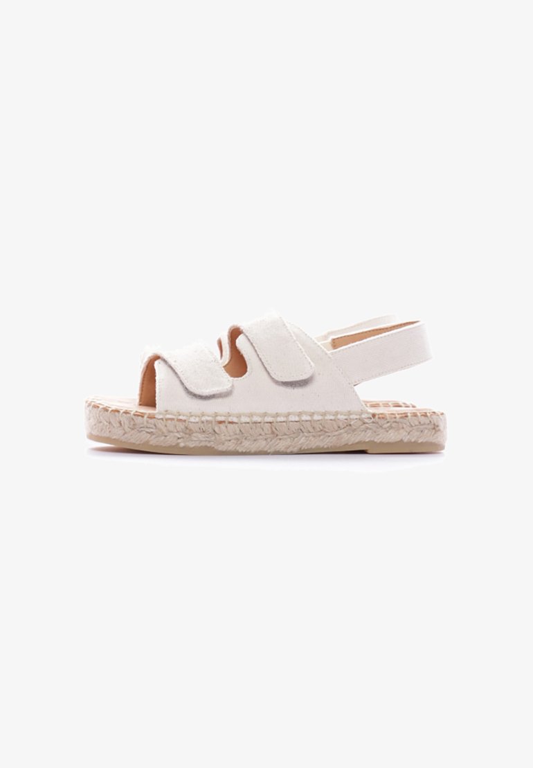 Sandali espadrilles bianchi in tela con due fibbie larghe, punta aperta e suola in juta intrecciata. Cinturino alla caviglia regolabile per una vestibilità sicura.