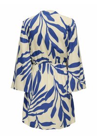 Robe crème avec imprimé abstrait de feuilles bleues, manches longues, taille froncée et ourlet court, vue de dos.