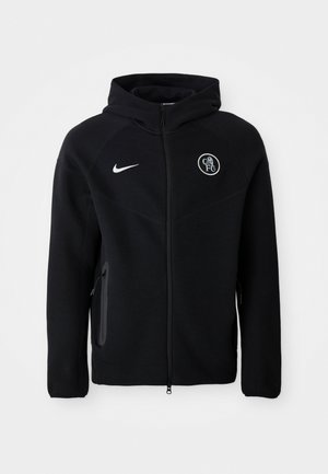 Zwarte zip-up hoodie van zachte stof, met een wit Nike-logo op de borst en een clubembleem. Inclusief zijzakken en een capuchon.