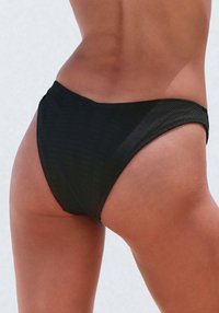 Black ribbed bikini bottom featuring a high-cut leg design and seamless edges. Smooth texture with a form-fitting silhouette.