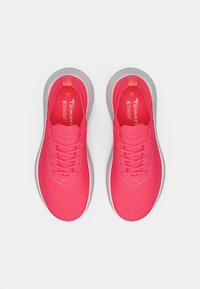 Ροζ αθλητικά παπούτσια με υφασμάτινη πλέξη, επίπεδα κορδόνια και μαλακή γκρίζα σόλα. Το εσωτερικό διαθέτει λογότυπο και ένδειξη μεγέθους.