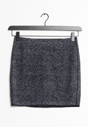 Donkergrijze tweed minirok met subtiele witte spikkels, hangend aan een zwarte klembroekhanger tegen een witte achtergrond.