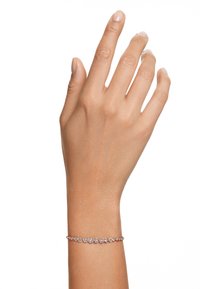 Roze gouden armband met een delicate ontwerp met ronde heldere edelstenen die gelijkmatig zijn gezet langs een dunne ketting, gedragen op een slanke hand.