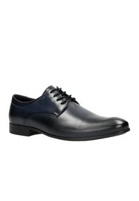Scarpa da uomo in pelle nera con finitura liscia, punta tonda, lace-up e tacco basso e texturizzato. Cuciture sottili e branding minimale.