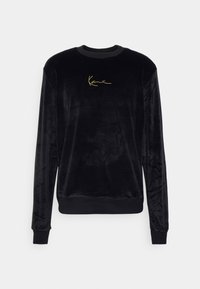 Czarna welurowa bluza z długimi rękawami i okrągłym dekoltem. Złote, haftowane logo na przodzie. Miękka w dotyku tekstura i dopasowany dół.