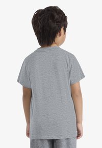 Gray short-sleeve t-shirt with a round neckline, featured on a child from the back. Material appears soft and textured.
